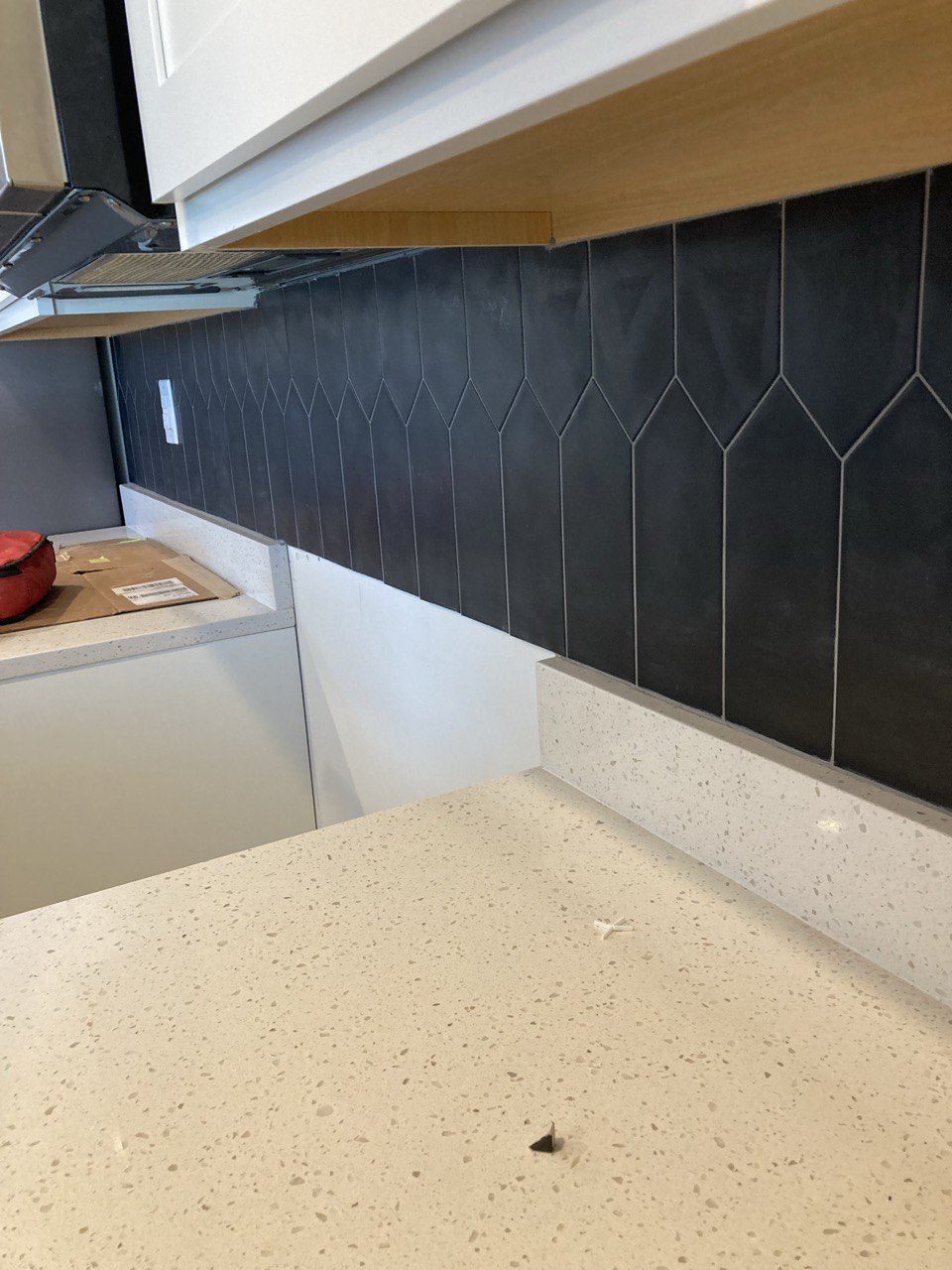 Kitchen backsplash in matte black picket tile
