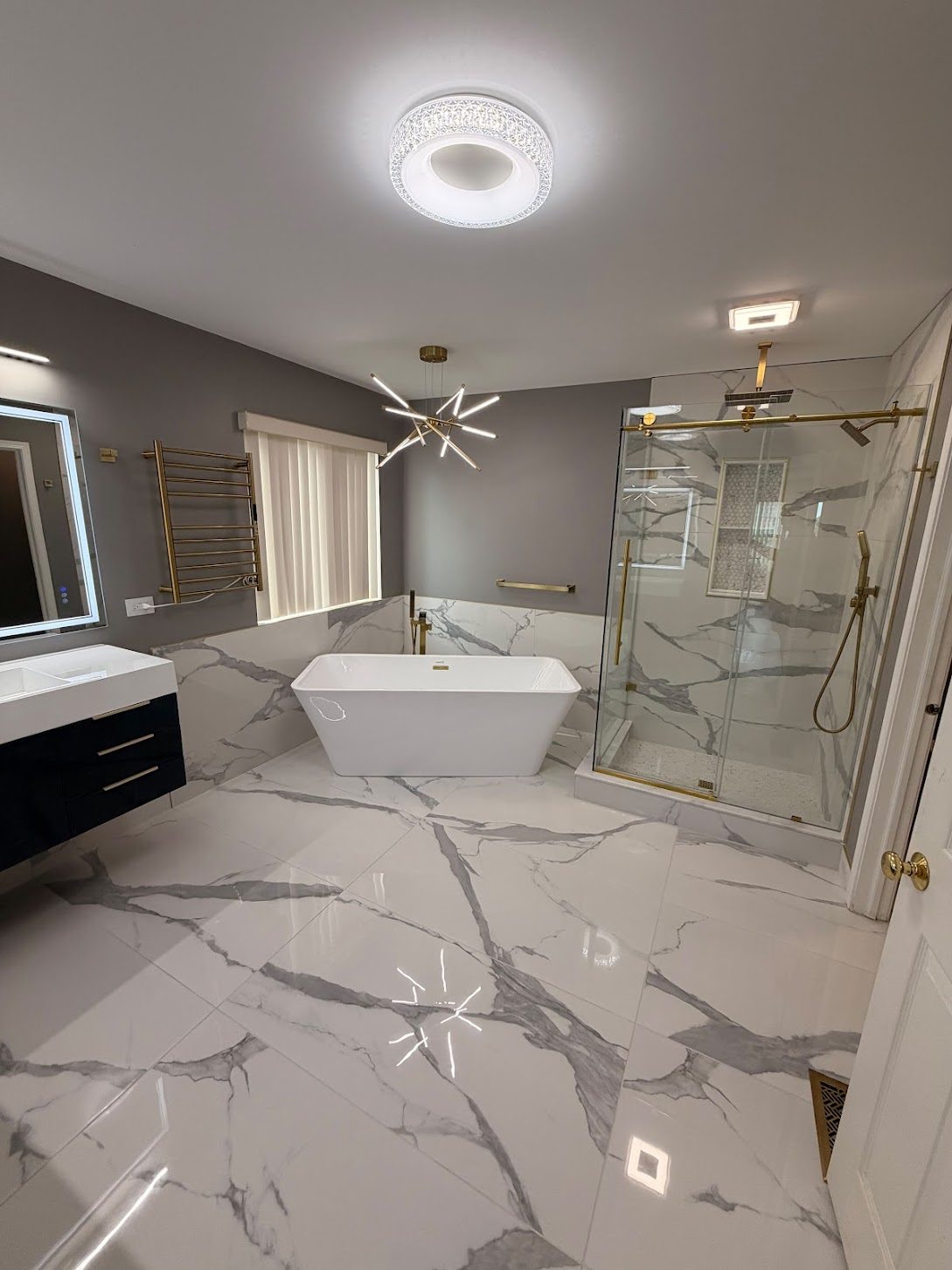 Finished bathroom showing painted wall and door beside the tiled tub